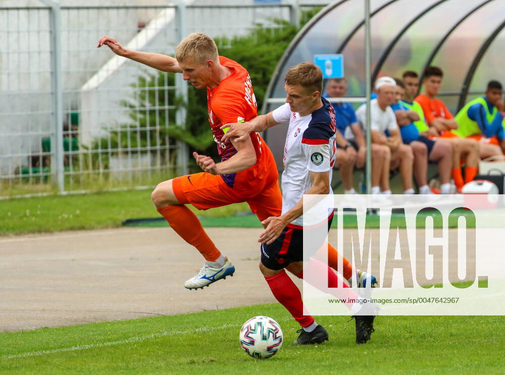 MINSK, BELARUS. FC Minsk player Andrey Shemruk (R) and FC Energetik-BGU player Alexey Nosko (L) in a 2020 Belarusian Premier League Round 18 football match between FC Minsk and FC Energetik-BGU at Tractor Stadium. FC Minsk won the match 2-1.