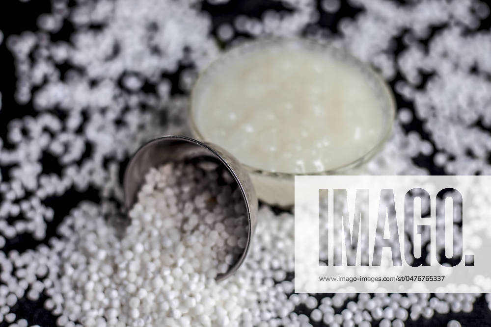 IMAGO Creative, Food, Tapioka Close up shot of sabudana ki kheer in a glass bowl along with some raw tapioca pearls and sugar spread on the surface.