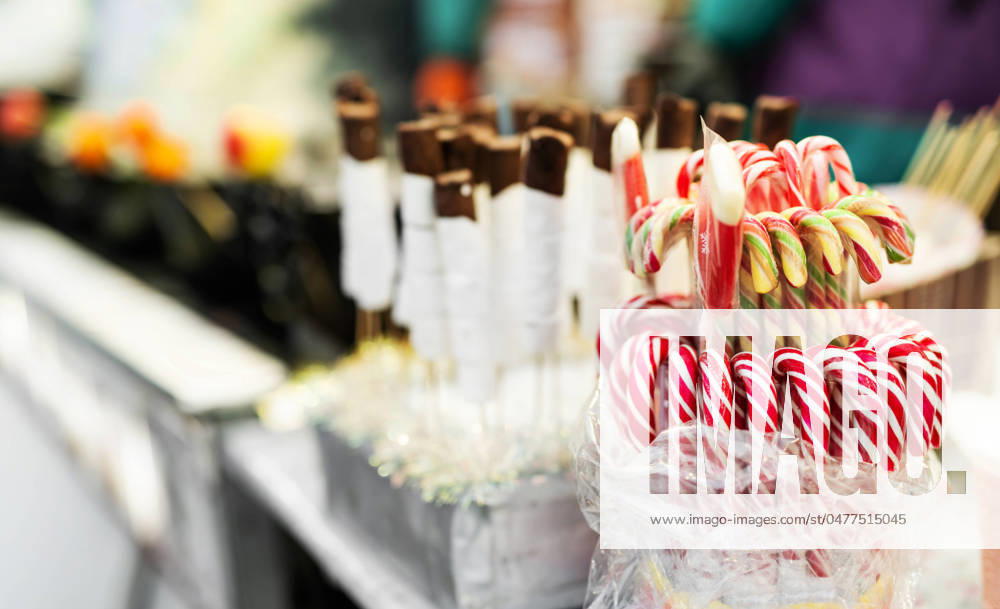 Traditional Christmas lollipop cane candies Traditional Christmas lollipop cane candies with red and white stripes at traditional street food festival market. Festive sweets at fair as symbol of Xmas