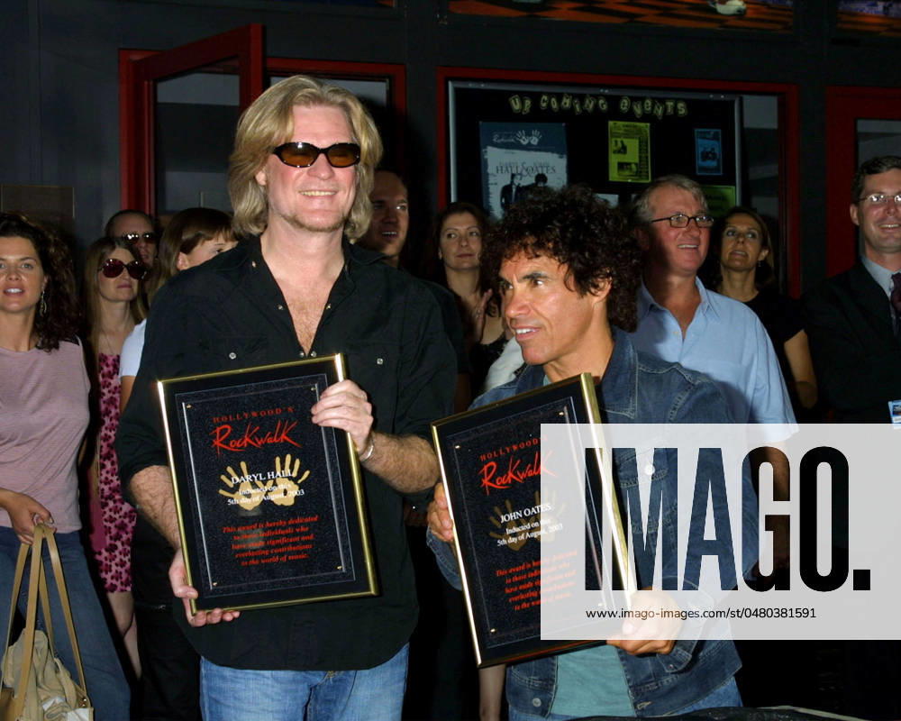2003 KATHY HUTCHINS HUTCHINS PHOTO.HOLLYWOOD S ROCKWALK INDUCTS.ROCK N SOUL DUO HALL & OATES IN .FROT OF GUITAR CENTER ON SUNSET BLVD,.HOLLYWOOD, CA 8 5 03...DARYL HALL AND JOHN OATES LOS ANGELES CA