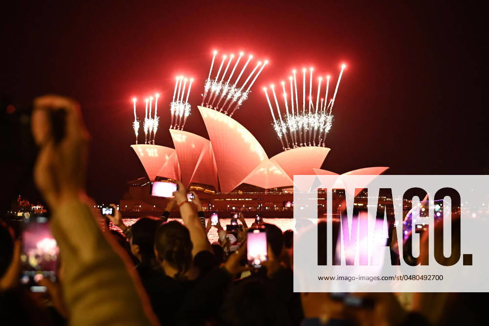 VIVID SYDNEY 2024, People watch as fireworks are launched behind the Sydney Opera House as part of 2024 Vivid Sydney in Sydney, Friday, May 24, 2024. Vivid Sydney will illuminate the Harbour City until Saturday 15 June. ( NO ARCHIVING, , NO USE IN BOOKS WITHOUT CONSENT SYDNEY NEW SOUTH WALES AUSTRALIA