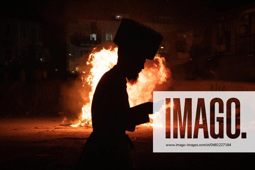 (240526) -- JERUSALEM, May 26, 2024 -- An Ultra-Orthodox Jewish person attends a fire burning ceremony as they celebrate the Jewish holiday of Lag BaOmer in Jerusalem, on May 25, 2024. ) MIDEAST-JERUSALEM-LAG BAOMER-CELEBRATION ChenxJunqing