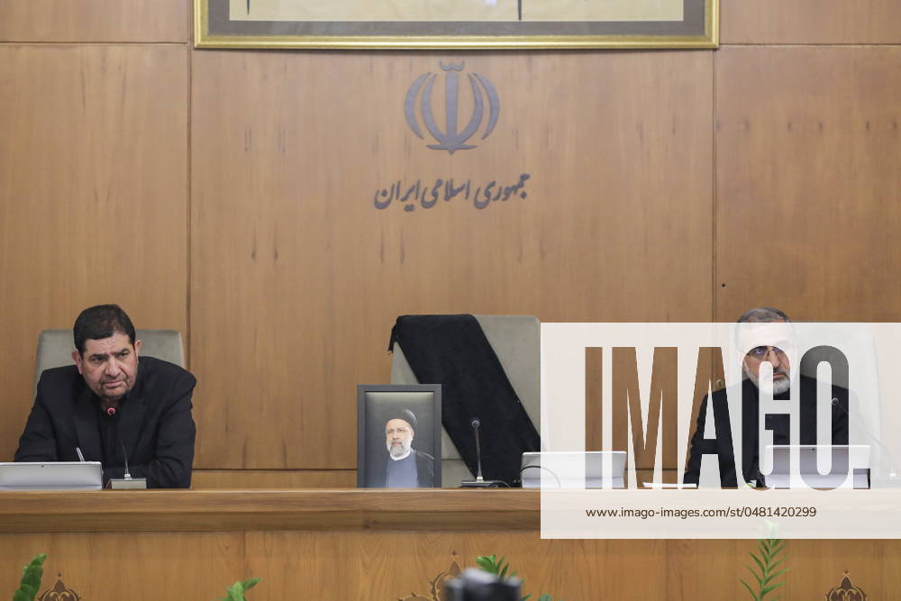Iranian Vice President and Acting President MOHAMMAD MOKHBER (L) speaks as a portrait of the late Iranian President Ebrahim Raisi (C) is placed on his seat after he was killed in a helicopter crash during a government meeting. Tehran Iran - ZUMAi98_ 20240526_zih_i98_002
