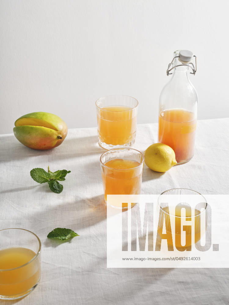 Glasses of homemade fermented kombucha drink with fruit flavour on white background Homemade fermented kombucha drink with fruit flavour on white background