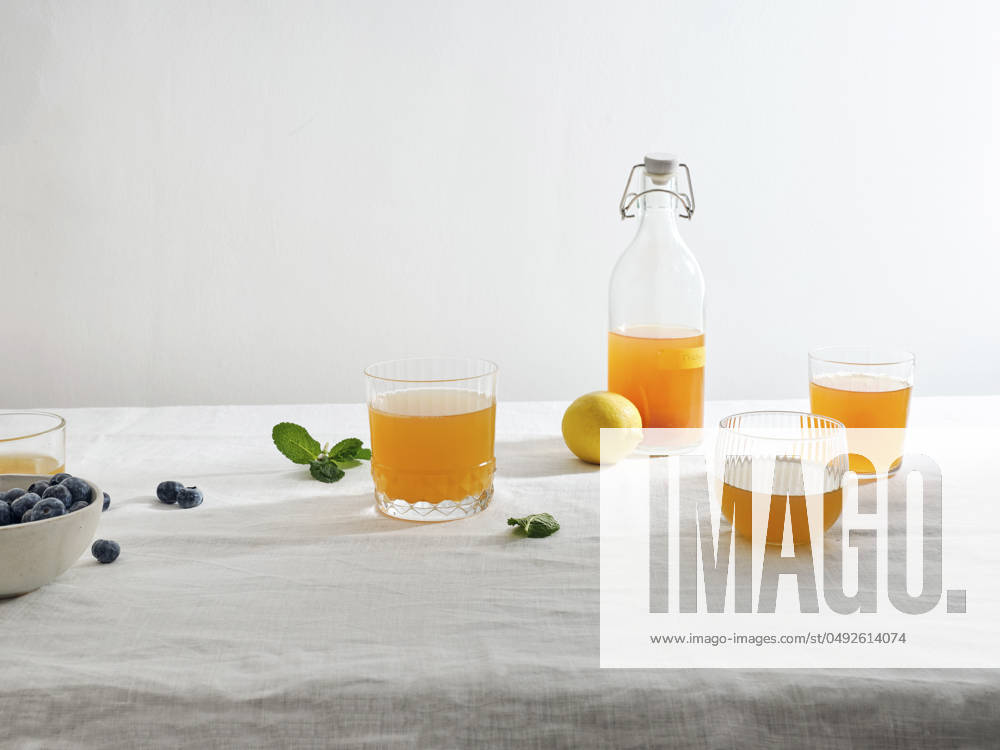 Glasses of homemade fermented kombucha drink with fruit flavour on white background Homemade fermented kombucha drink with fruit flavour on white background