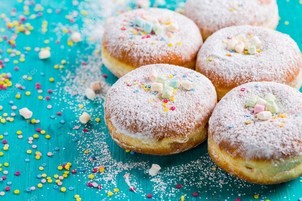 Carnival powdered sugar raised donuts - German Berliner donuts, Krapfen filled with jam
