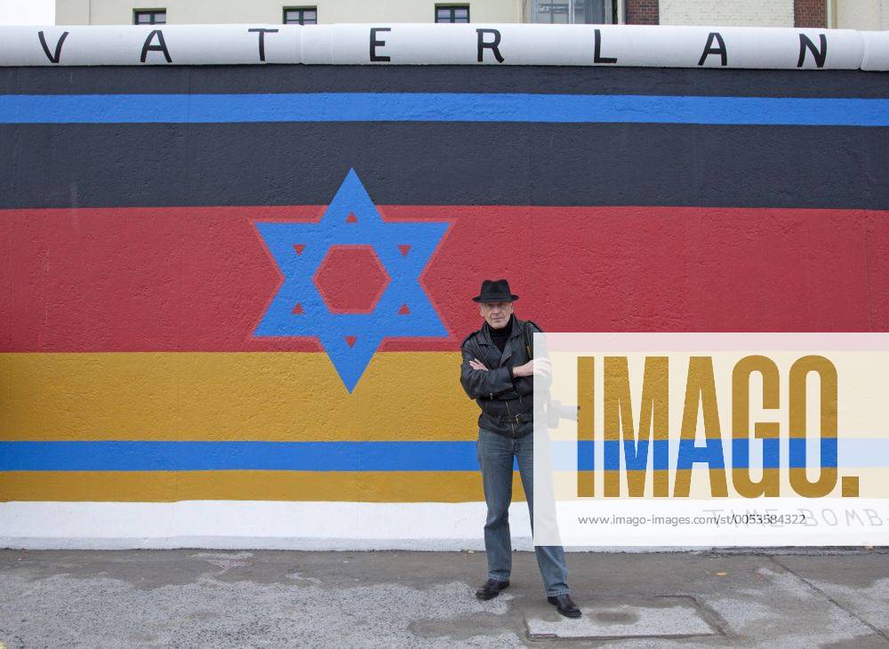 Artist Günther Schäfer stands in front of a segment of the original Berlin wall in Berlin on November 6, 2009. Schaefer painted this segment of the wall in 1990 after the fall of then East Germany and, as part of a ceremony commemorating the 20th anniversary of the fall, recently restored his work. This site, located at the East Side Gallery, is the longest, best kept segment of the original wall. UPI Photo David Silpa BER20091106702