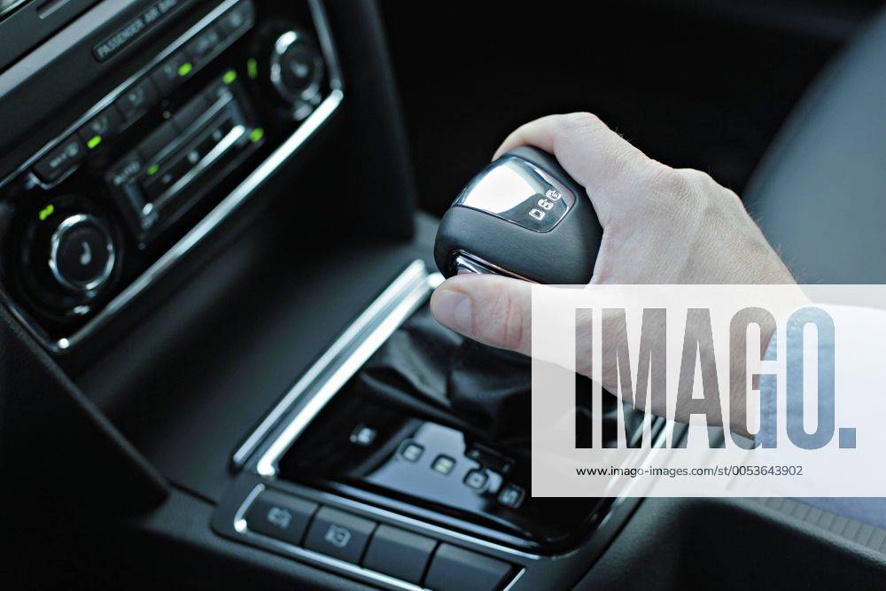 Man hand on an automatic gear stick, lever, gear box DSG, in a new luxury passenger car Skoda Superb Combi. At left is automatic air-conditioning. (CTKxPhoto RenexFluger) rfl
