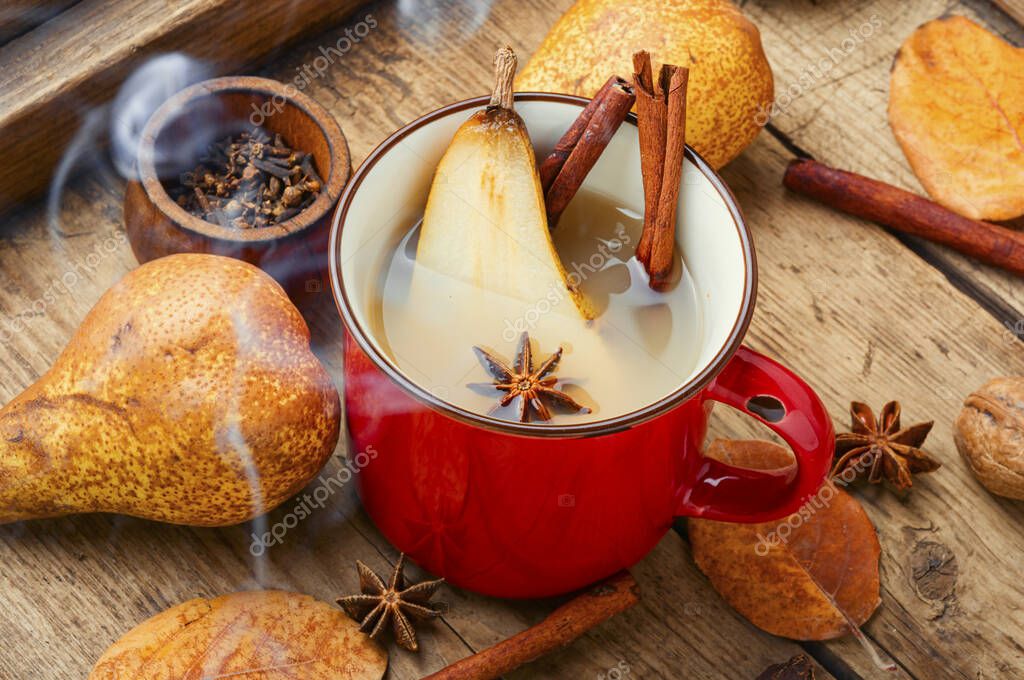 Traditional autumn alcoholic drink.Warm pear mulled wine.Pear wine on old vintage wooden table