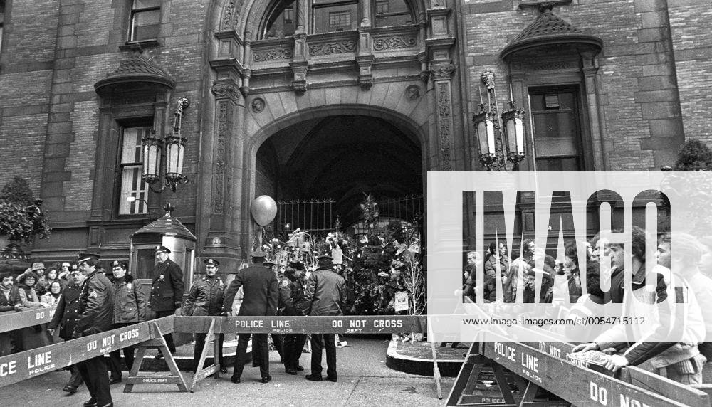 John Lennon was shot down outside his home - Dakota House - in New York mourners gathered outside the home in honor and leave flowers - KP031002