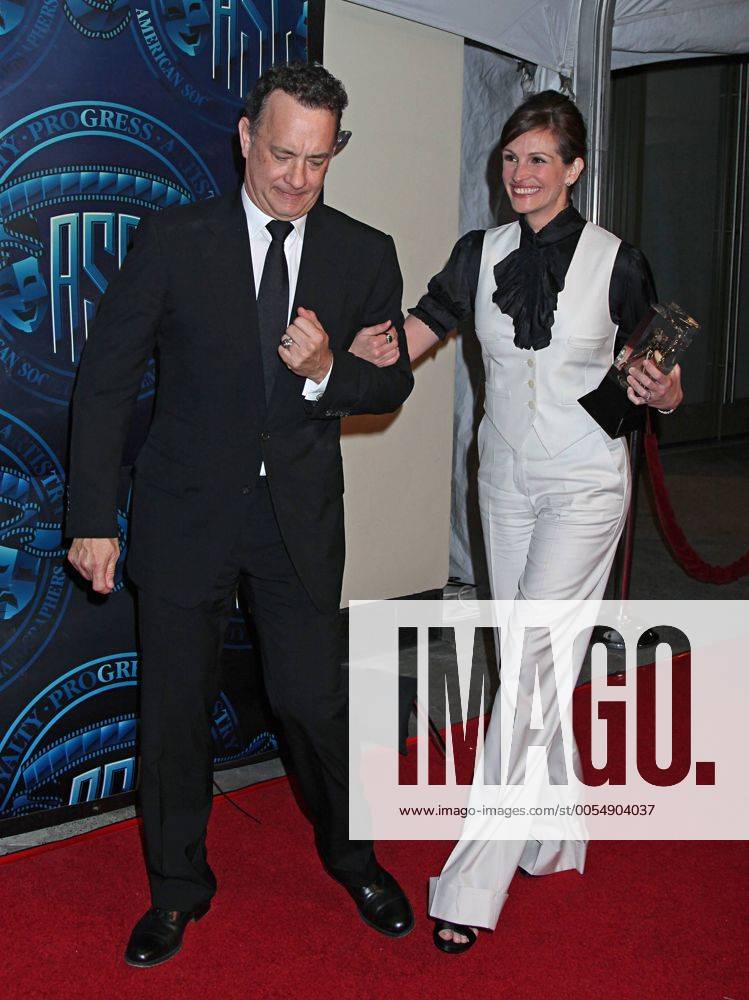 Tom Hanks and Julia Roberts arrive on the red carpet after Roberts received the Board of Governors Award during the 25th annual American Society of Cinematographers Awards in the Hollywood section of Los Angeles on February 13, 2011. LAP20110213723