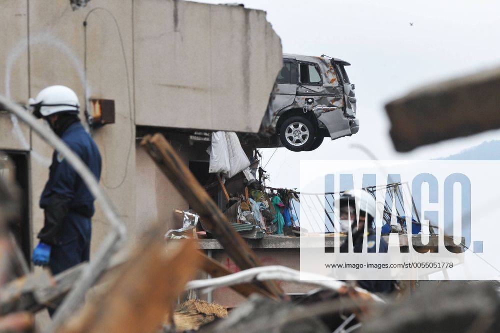 (110322) -- IWATE (JAPAN), March 22, 2011 (Xinhua) -- Rescuers work in quake-devastated Iwate Prefecture, Japan, on March 21, 2011. The tsunami disaster has actually inundated a large area behind the board. The National Police Agency said Tuesday that the catastrophic earthquake and ensuing tsunami have left 9,079 people dead and 12,645 others unaccounted for in Japan by 12:00 local time (0300 GMT). (Xinhua Huang Xiaoyong) (lr) JAPAN-IWATE-QUAKE-AFTERMATH