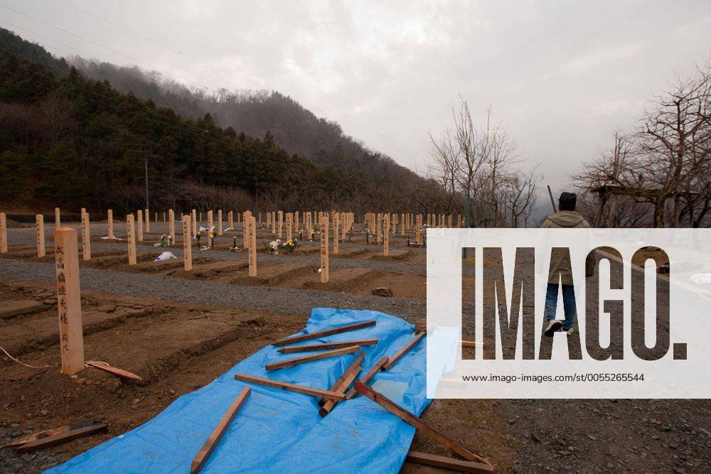 Onagawa, Japan - A photo made available on April 11 shows Yoshikatsu Hiratsuka, 66, walk to where his wife and mother rest in peace at a temporary mass grave for the March 11 earthquake and tsunami victims. Yoshikatsu was visiting a friend at the time the earthquake hit and he quickly rushed back home to later see his wife and mother in front of the house thinking how to escape. Before the two could react to a plan to escape, the 10-meter tsunami swept them away, leaving Yoshikatsu to live. His son is still missing and continues to search for him everyday. (xjrb000780)