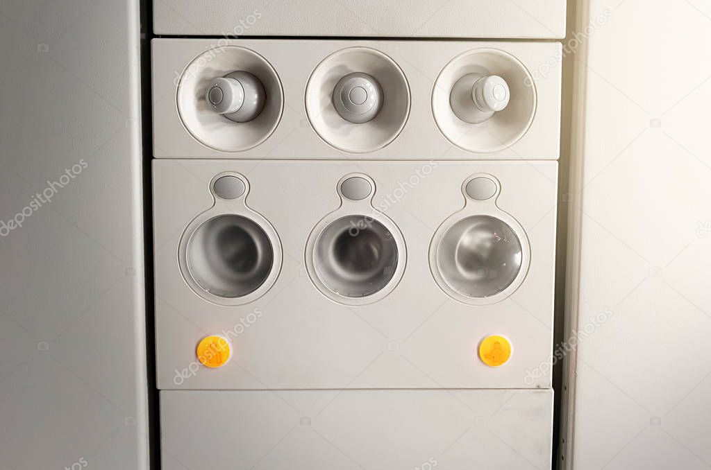 Adjustable lights and air conditioners overhead seat controls of a commercial aircraft. Closed air conditioners nozzles