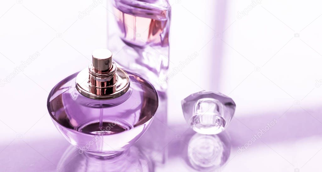 Perfumery, spa and branding concept - Purple perfume bottle on glossy background, sweet floral scent, glamour fragrance and eau de parfum as holiday gift and luxury beauty cosmetics brand design