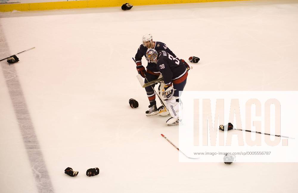 Feb. 28, 2010 - Vancouver, British Columbia, Canada - Olympics Men s Hockey - USA s goalie Ryan Miller and USA s Brooks Orpik skate through discard helmets from Canada team after they beat the USA 3-2 in overtime in Men s GoldMedal Hockey game at the 2010 Winter Olympic on February 28, 2010 in Vancouver, British Columbia. - ZUMAj89 o0 enttäuscht Equipment