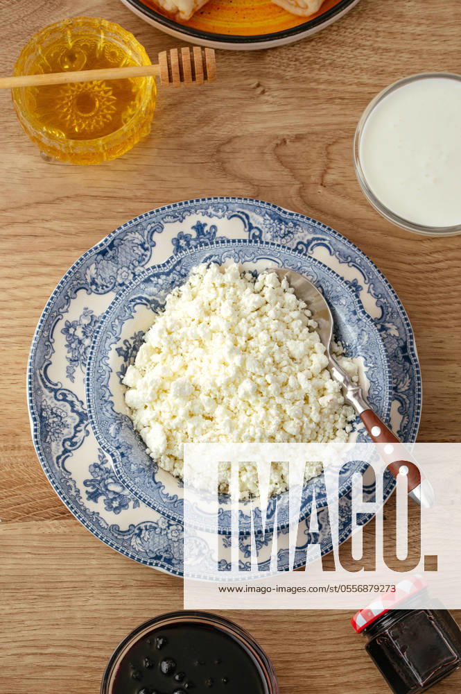Cottage cheese in a plate on the table R_KUAL24061193-1456627-01