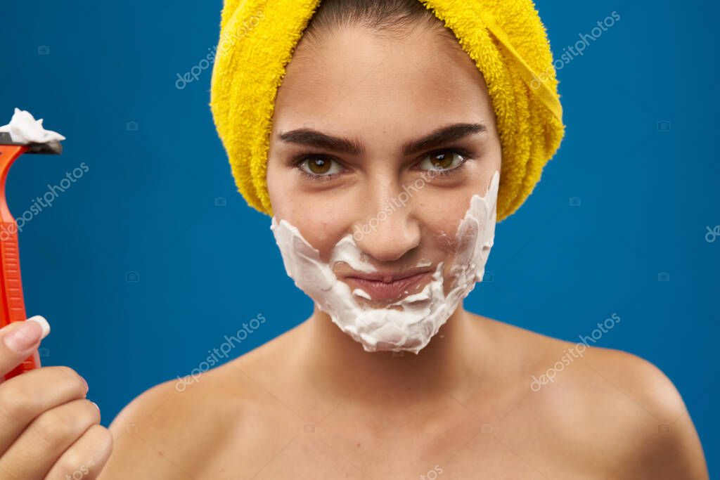 Cheerful woman razor in hand skin care hygiene Lifestyle. High quality photo model released