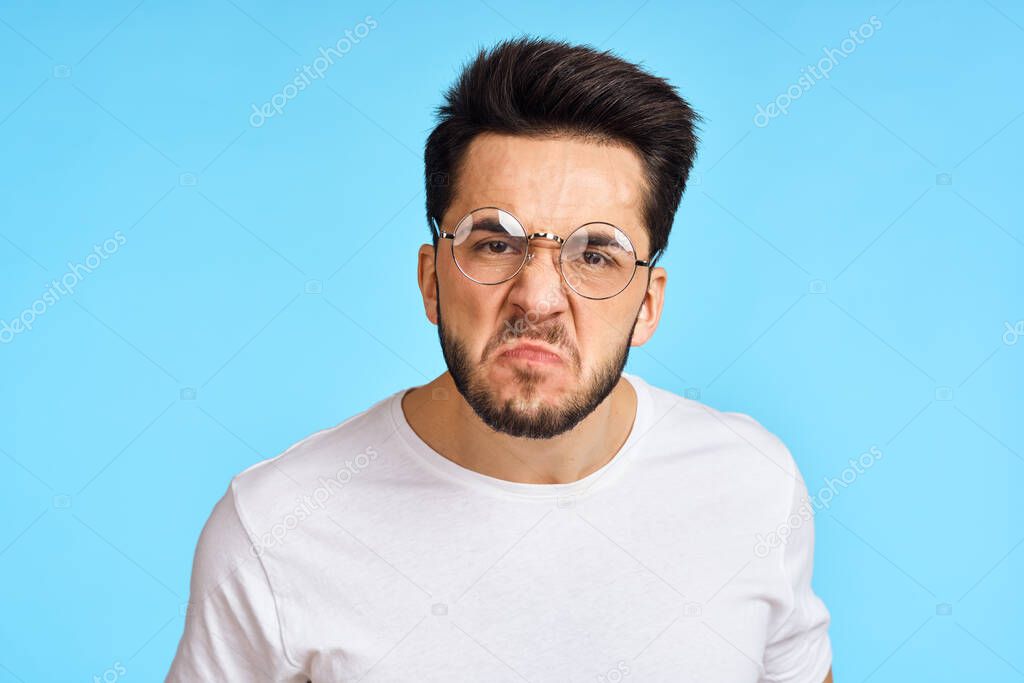 Man in white t-shirt notebook with pen student blue background. High quality photo model released