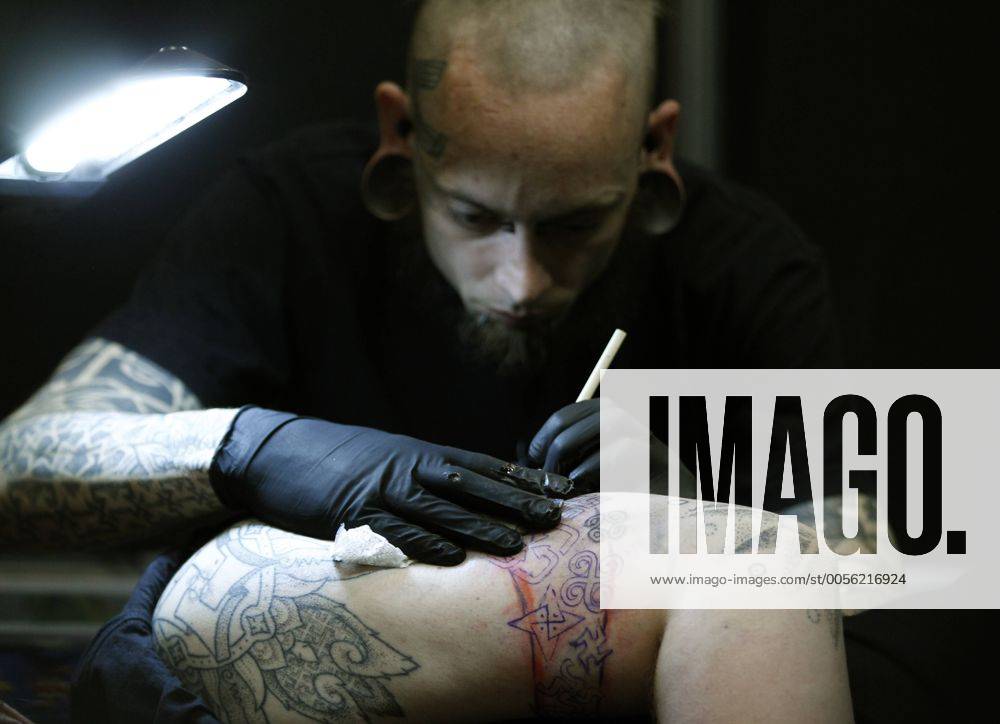 Tätowierer sticht ein Tattoo am 28.5.11 bei der Tattoo Convention in Dortmund