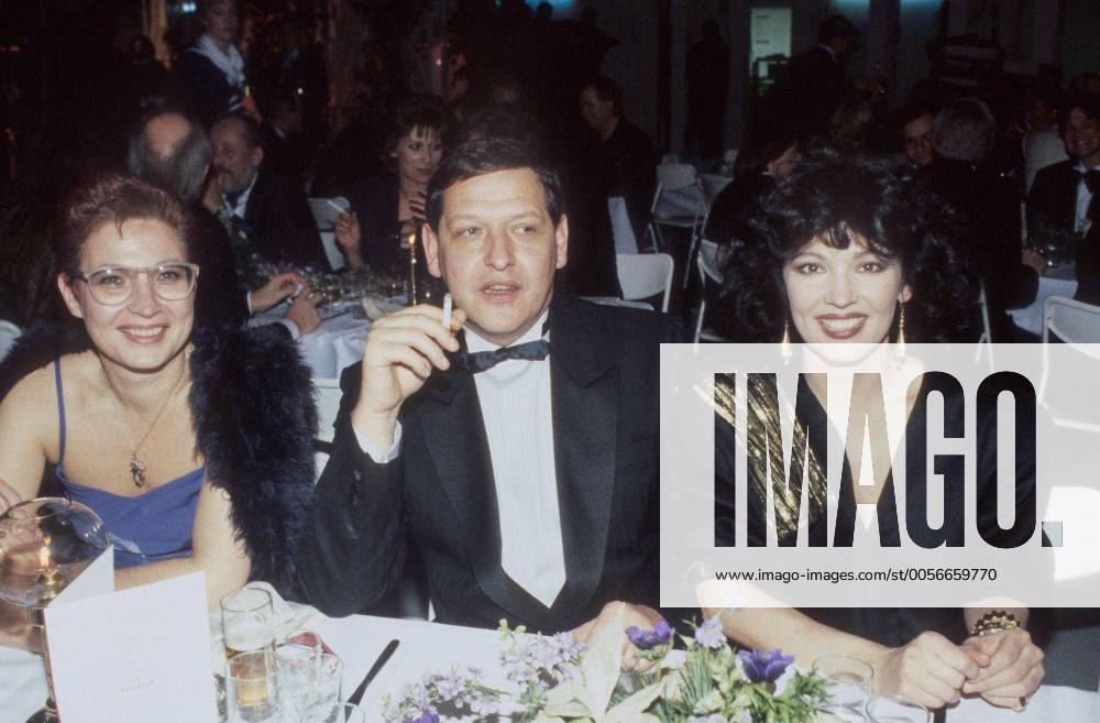 Diether Krebs mit Ehefrau Bettina von Leoprechting (li.) und Iris Berben 12 86 rag Schauspiel Fernsehen TV Film Komik Comedy dunkelhaarig festlich sitzend Tisch Saal dunkel Kerze Gesteck Blume Blumenstrauß Zigarette halb quer lächelnd