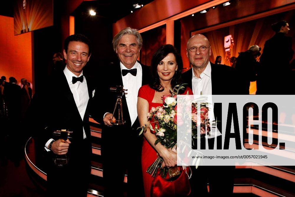 Produzent Oliver BERBEN (links) erhält die Goldene Kamera in der Kategorie Bester Deutscher Fernsehfilm für den Film Liebesjahre , hier mit seiner Mutter der Schauspielerin Iris BERBEN, 2. von links Schauspieler Peter SIMONISCHEK, rechts nicht identifizierter Gast, 47. Verleihung der Goldenen Kamera, der Film-und Fernsehpreis der Zeitschrift HÖRZU im Berliner Verlagshaus der Axel Springer AG in Berlin am 04.02.2012. Poolfoto