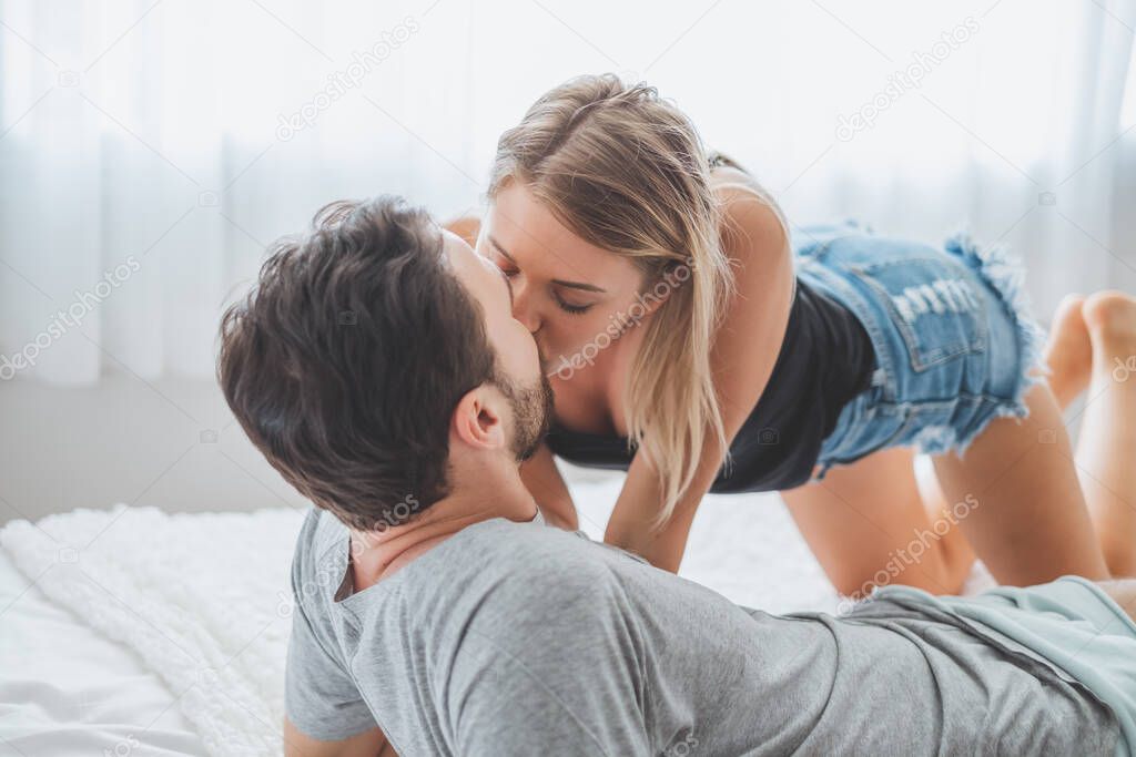 Happy couple lover on bed, hug and kiss in romantic time, love and passionate concept. model released