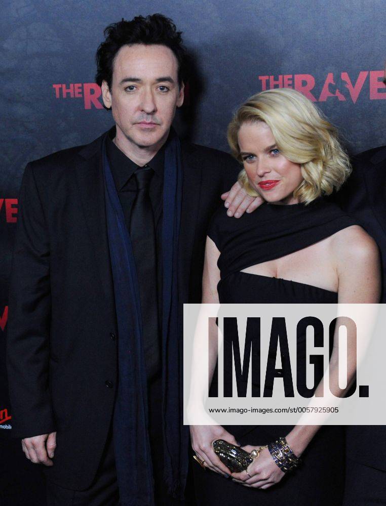 Actor John Cusack (L) and Alice Eve, cast members in the motion picture mystery thriller The Raven , attend the premiere of the film at the Los Angeles Theatre in the downtown section of Los Angeles on April 23, 2012. LAP2012042308