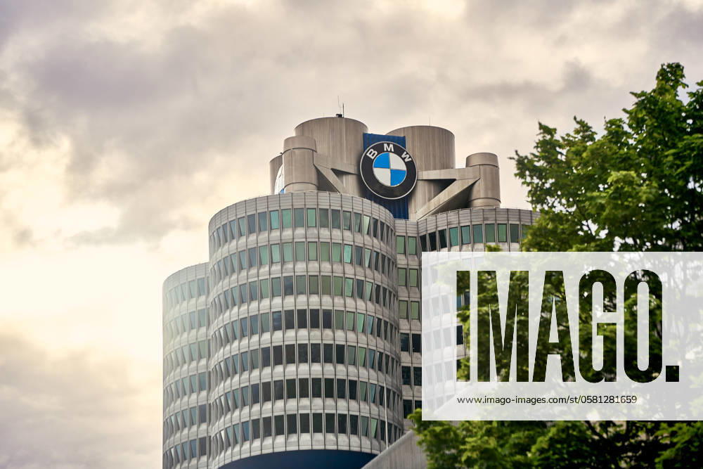 The BMW headquarters in Munich, Germany, under a cloudy sky. The modern high-rise building with its striking design and the BMW logo is a landmark of the city