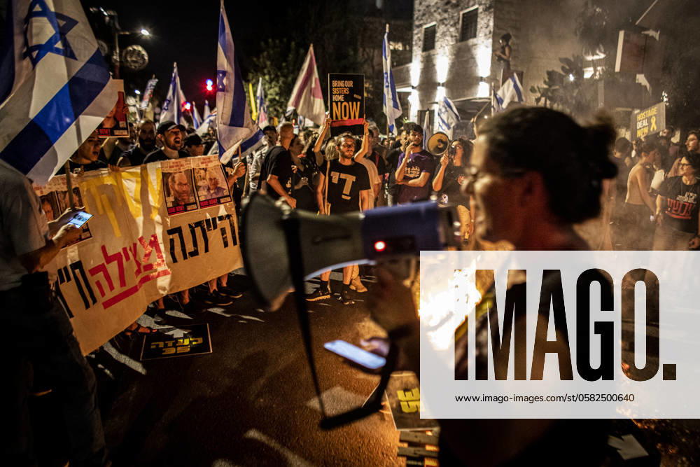 Anti Government Protest in Jerusalem Ayala Metzger chants with load speaker as protestors wave signs and the Israeli flag during a demonstration in Jerusalem, Monday, June 17 2024. Israeli Anti-government protesters rallied in Jerusalem Monday, some clashed with police near the home of Prime Minister Benjamin Netanyahu calling for new elections and a hostage deal with Hamas. Netanyahu dissolved the war cabinet on Sunday in an attempt to defuse demands by the far-right members of his coalition to be included in what has been a small forum that has charted the direction of the Gaza war since October 7. Photo by Eyal Warshavsky. Jerusalem Israel