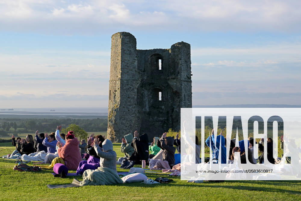 Summer Solstice Sunrise A Yoga class in the grounds of Hadleigh Castle in Essex UK greet the sunrise on the morning of the summer solstice. The sun rose at 04:40am and sets at 9:19pm on what is the longest day of the year. The official time of the summer solstice in the UK is 9:50pm on 20 June 2024. Essex Hadleigh Castle UK