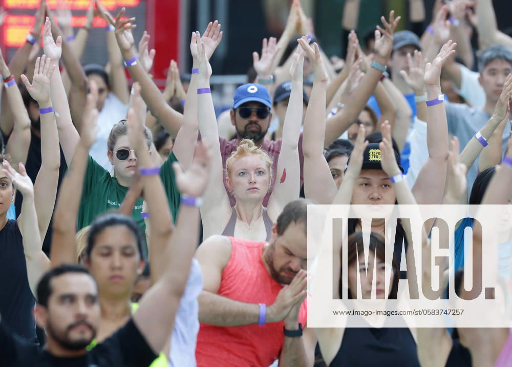 People attend a yoga class in celebration of the summer solstice at an 22nd annual all-day outdoor yoga event in Times Square in New York City on Thursday, June 20, 2024. NYP20240620112 JohnxAngelillo