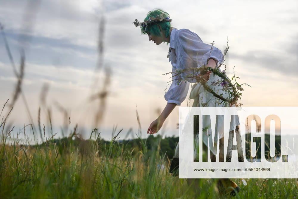 Summer Solstice Celebration In Poland A girl is picking wild plants while celebrating the summer solstice during the Kupala Night by the Krakus Mound in Krakow, Poland on June 20th, 2024. The KupaÅ‚a Night is Old Slavic holiday falling on the shortest night of the year. During that night rituals were performed such as gathering and making crowns from herbs and wild flowers by girls and young women, sending garlands on water; lighting fires, dancing, singing, and jumping over fire. Krakow Poland