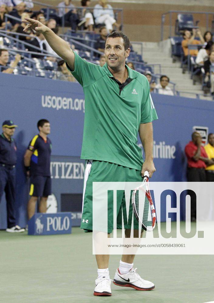 Adam Sandler reacts with fans while playing in a doubles exhibition match with Kevin James, Jim Courier, and John McEnroe on day 11 in Arthur Ashe Stadium at the Billie Jean King National Tennis Center in New York City on September 6, 2012. NYP20120906134