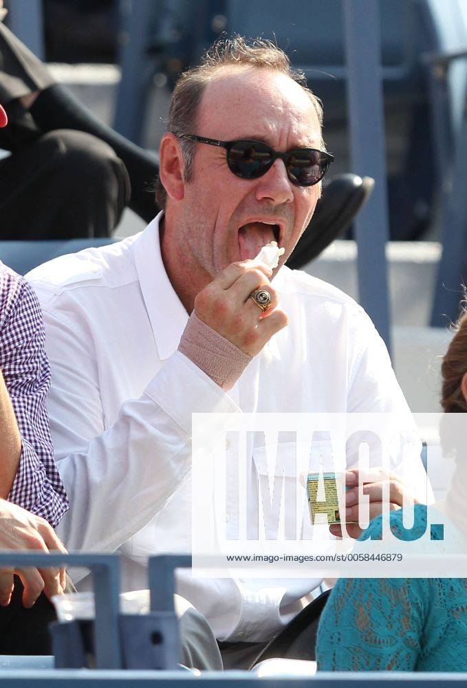 US Open 2012, USTA Billie Jean King National Tennis Center, Flushing Meadows, New York, ITF Grand Slam Tennis Tournament,Schauspieler Kevin Spacey mit Eiscreme sitzt als Zuschauer auf der Tribuene, Einzelbild,Halbkoerper, Hochformat,Feature,VIP,Ehrengast,