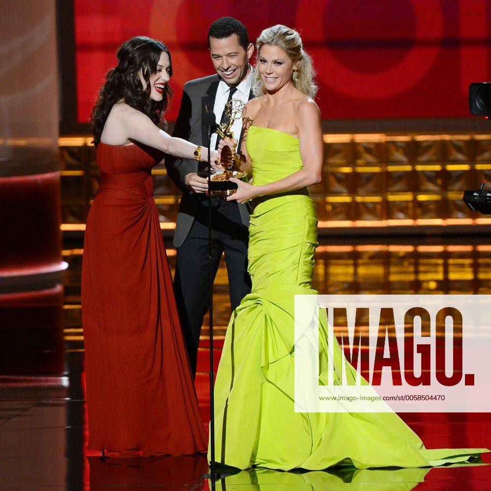 Actress Kat Dennings (L) and actor Jon Cryer present the Emmy Award to actress Julie Bowen onstage at the 64th Primetime Emmys at the Nokia Theatre in Los Angeles on September 23, 2012. LAP20120923124