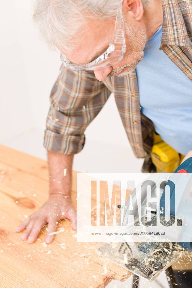 Home improvement - handyman cut wood with jigsaw in workshop CTKPhotoF201209191067201 089_074_241110