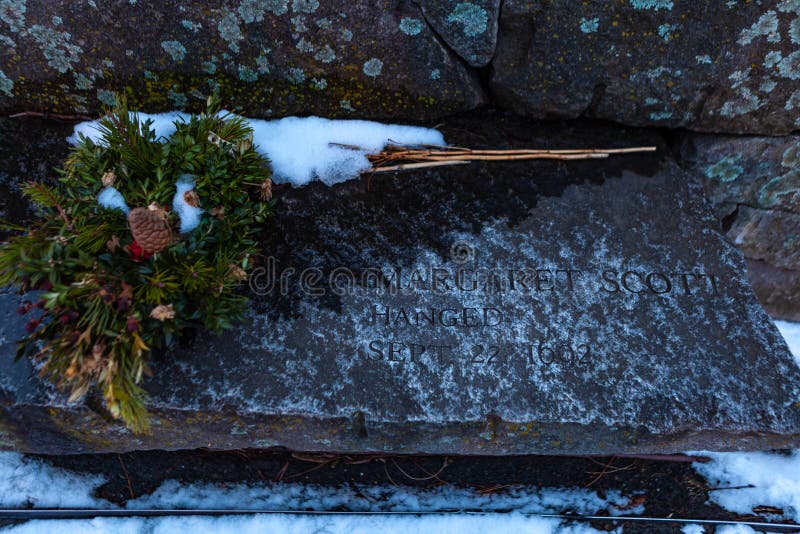 Salem, USA- March 03, 2019: one of 20 memorial slabs located in a tiny memorial park. In 1692, 14 women and 6 men were falsely, One of 20 memorial slabs located in a tiny memorial park. In 1692, 14 women and 6 men were falsely accused, found guilty by trial, and then executed as a witch. A memorial park, built three hundred years later in 1992, sits next to the cemetery and Pickman House. It hosts twenty granite benches built into a granite wall