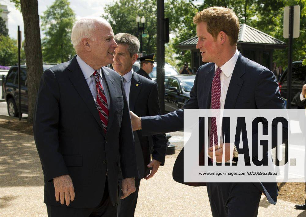 Prince Harry (R) is greeted by Sen. John McCain (R-AZ) as he arrives on Capitol Hill to tour a photography exhibit by HALO Trust, a British nonprofit focused on removing hazardous war debris, including un-exploded devices and landmines, on May 9, 2013 in Washington, D.C. WAP20130509315