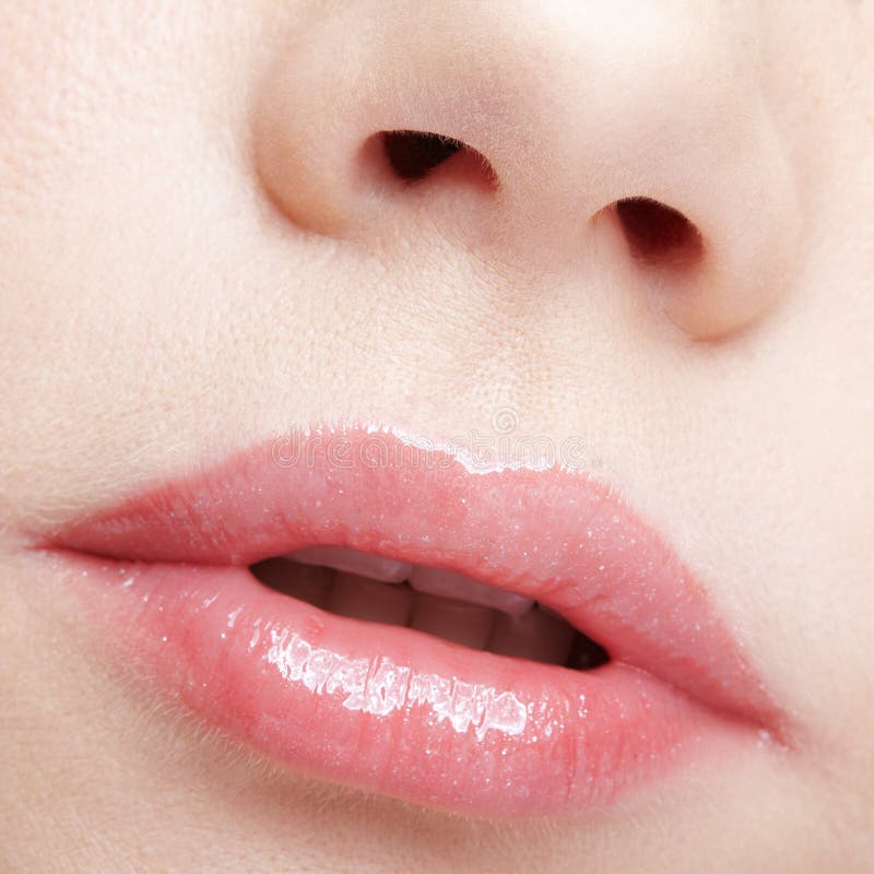 Closeup macro portrait of female part of face. Human woman lips with day beauty makeup, Human mouth and nose. Closeup macro portrait of female part of face. Woman lips with day beauty makeup model released