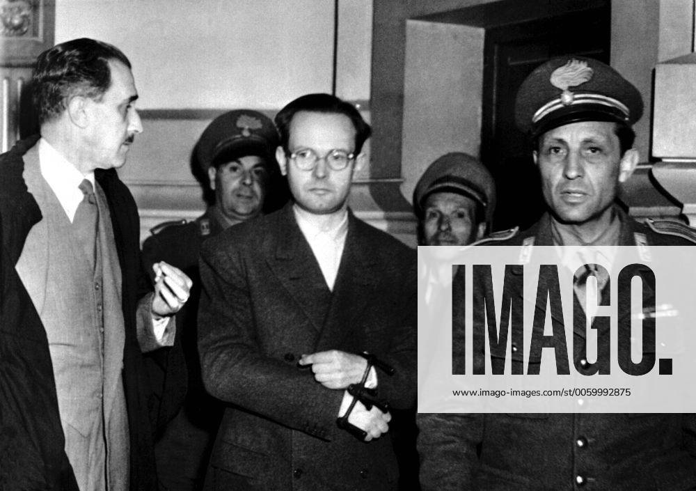 Monsignor Edward Prettner Cippico, Handcuffed, enters the court to face his trial for embezzling money. 23rd April 1949. UnitedArchives00475628