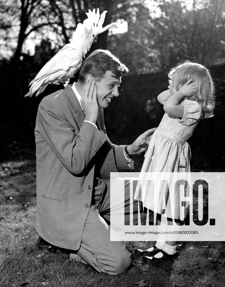 IMAGO ICONS: Sir David Attenborough 3 year old Susan and her father David Attenborough cover their ears as sulphur crested cockatoo Georgie lets out a piercing shriek. 7th December 1957. UnitedArchives00563834