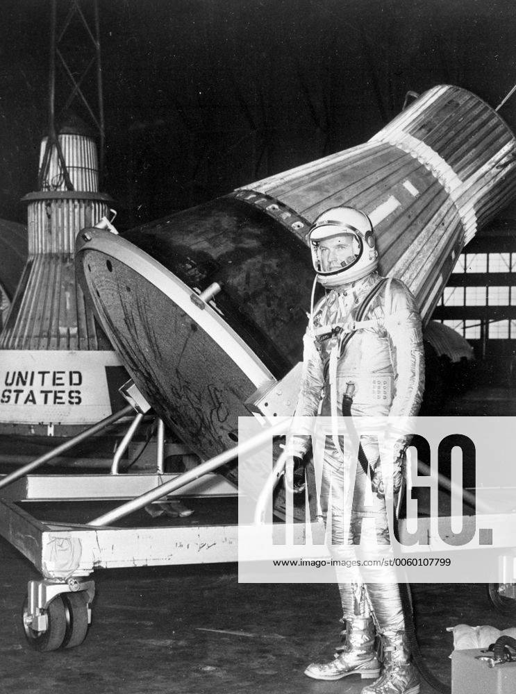 Langley Field, VA: Wearing an aluminiumized space suit, Mercury Astronaut L. Gordon Cooper of Carbondale Colo., stand near a project Mercury Capsule at Langley Field recently, The capsule, and another seen in background, are prototypes of the one in which Cooper or one of the six astronauts will ride into space next year. 3 October 1960 UnitedArchives00938058