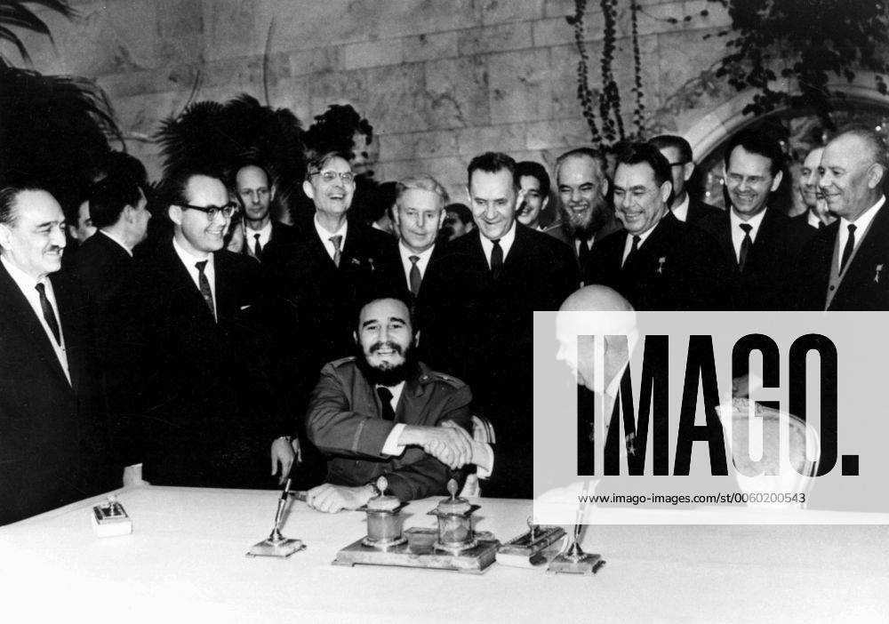 Cuban Premier Fidel Castro (seated left) shakes hands with Soviet Premier Nikita Khruschev after they had penned their signatures to an £ 890,000,000 sugar deal in the Kremlin here, 21st January 1964. On the extreme left is Soviet First Deputy Premier Anastas Mikoyan. Castro flew home on 23rd January after a ten day visit. UnitedArchives01004409
