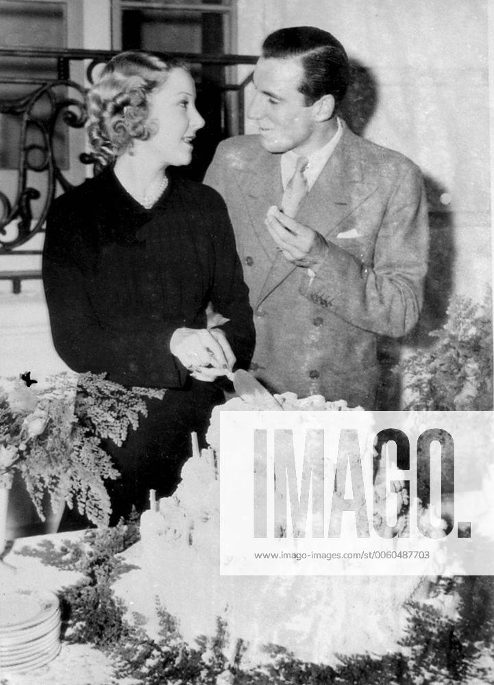 Fred Perry (the British tennis champion) and his bride Miss Helen Vinson (the film actress) were welcomed to Hollywood after their New York wedding with a surprise party in celebration of Miss Vinson s birthday Photo shows Fred Perry tasting the birthday cake cut by his bride Helen Vinson 26th September 1935 UnitedArchives00954275