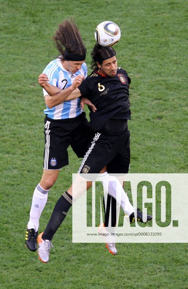 Sami Khedira (R) of Germany heads the ball with Martin Demichelis of Argentina during their 2010 World Cup quarterfinal soccer match at Green Point stadium in Cape Town on July 3, 2010.