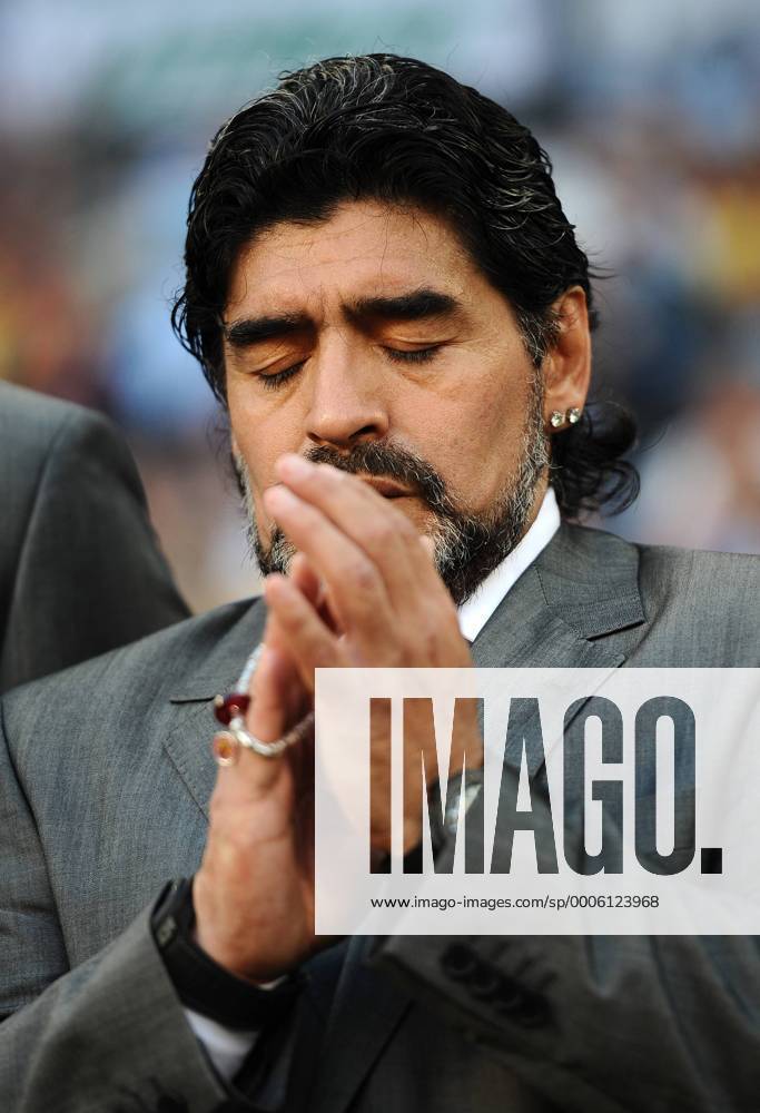 Football - 2010 FIFA World Cup - QuarterFinal - Argentina vs. Germany Diego Armando Maradona coach of Argentina preys before kick off at Green Point Stadium, Cape Town