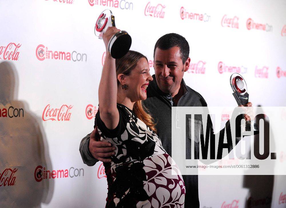 Female Star of the Year award winner Drew Barrymore (L) and Male Star of the Year award winner Adam Sandler arrive at the CinemaCon awards ceremony at the Pure Nightclub at Caesars Palace during CinemaCon, the official convention of the National Association of Theatre Owners in Las Vegas, Nevada onMarch 27, 2014. LVP2014032740