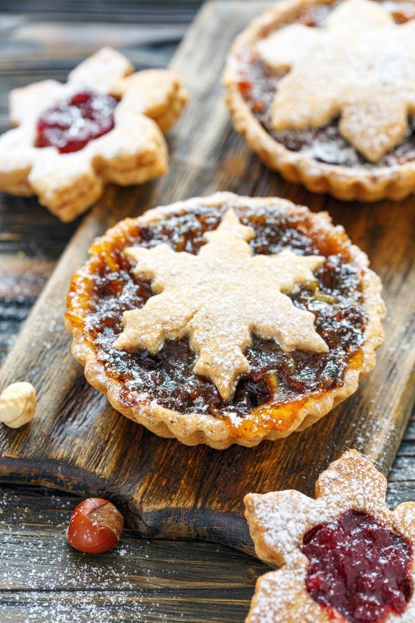 Cakes with dried fruits, orange jam and nuts., Christmas cakes with dried fruit and nuts on wooden table, selective focus.