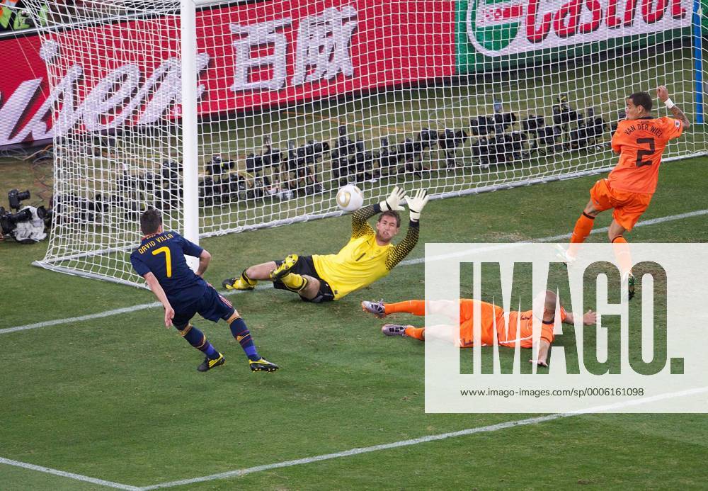 Football - 2010 FIFA World Cup - Final - Spain vs. Netherlands David Villa (L) of Spain s shot is deflected over the bar by John Heitinga (2R) next to goalkeeper Maarten Stekelenburg (2L) and Gregory van der Wiel of the Netherlands at Soccer City Stadium, Johannesburg